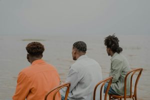 men of different hairstyles looking at sea