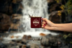 person holding red mug