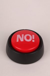 red no button on white surface